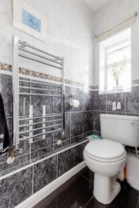 a bathroom with a toilet and a glass shower at Single Room with shared bathroom in Cheshunt +36 photos