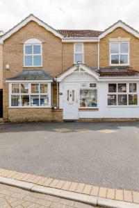 a large brick house with a white door at Single Room with shared bathroom in Cheshunt