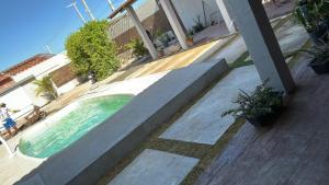 a swimming pool on the side of a house at Recanto Esmeralda in Fortim