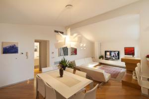 a living room and dining room with a table and chairs at Loft In Master Palace in Catania