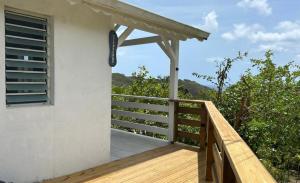 a balcony of a house with a wooden railing at Bungalow Kaz à Céli in Deshaies