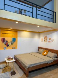 a bedroom with a bed and a loft at Muối Vừng Home in Ða Gia