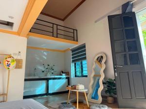 a living room with a door and a table at Muối Vừng Home in Ða Gia