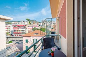 a balcony with a table and a view of a city at Artemisia in Varazze