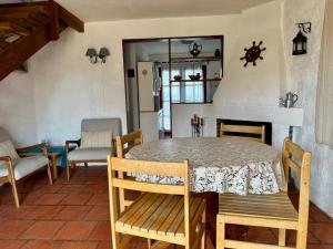 a dining room with a table and chairs and a fireplace at Brisas del Diablo 1 in Punta Del Diablo