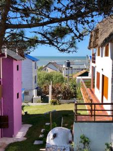 a group of houses with the ocean in the background at Brisas del Diablo 1 in Punta Del Diablo