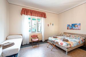 a bedroom with two beds and a window at Artemisia in Varazze