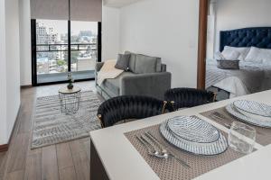 a living room with a table and a couch at 1503 A - INARA Downtown Four in Guatemala