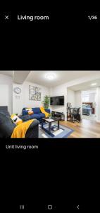 a living room with a couch and a living at Plush Suite Pet Friendly 326 Mbps Wi-Fi in Airdrie