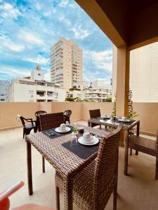 a patio with tables and chairs on a balcony at Pousada Ilha das Conchas in Guarujá