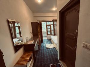 a room with a bedroom with a bed and a bathroom at Sarai Stay in Kargil