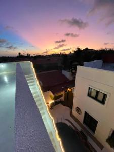 a view of a building and a swimming pool at sunset at Villa Veríssimo in Jericoacoara +70 photos