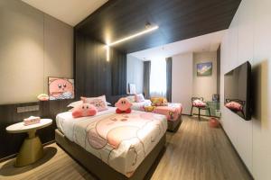 a bedroom with two beds with hello kitty pillows at Xi'an Jing - Scenery Hotel in Xi'an