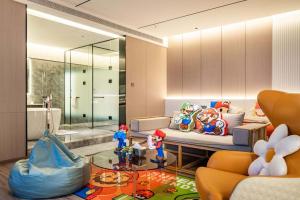a living room with toy figurines on a glass table at Xi'an Jing - Scenery Hotel in Xi'an