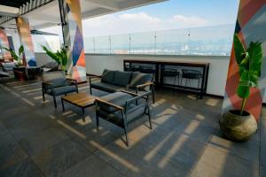 a lobby with chairs and a table in a building at Ceiling INARA 1503 B in Guatemala