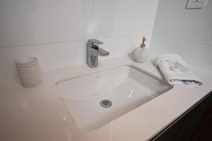 a white sink in a white bathroom at Ceiling INARA 1503 B in Guatemala +9 photos