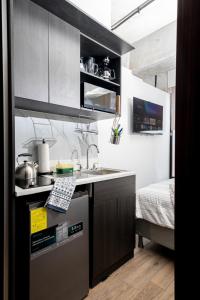 a small kitchen with a sink and a stove at Ceiling INARA 1503 B in Guatemala