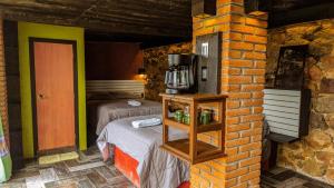a room with a bed and a brick wall at Habitacion corralito in San Jose del Pacifico