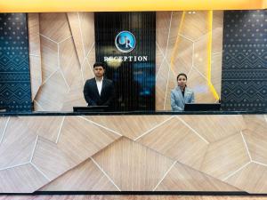 a group of three men sitting at a reception desk at Dhaka Unique Regency in Dhaka +50 photos