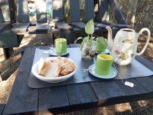 a table with a plate of bread and cups on it at Mostepa in Carpintería
