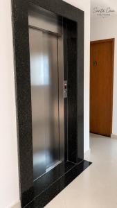 a stainless steel elevator in a building at Hotel Pousada Santa Ceia in Aparecida +35 photos
