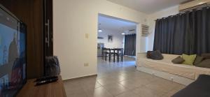 a living room with a bed and a dining room at Casa de Agus - Con pileta climatizada in Córdoba