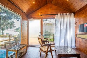a room with a balcony with a table and chairs at Leopard Inn Arugam Bay in Arugam Bay