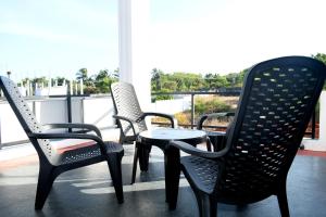 a group of chairs and a table on a balcony at Lasya Residence in Trincomalee +4 photos