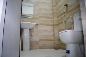 a bathroom with a toilet and a sink at Lasya Residence in Trincomalee