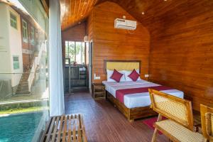 a bedroom with a bed and a swimming pool at Leopard Inn Arugam Bay in Arugam Bay +128 photos