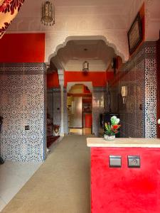 a kitchen with a red counter in a room at Tafoukt 2 in Kasba Aït Youdi +2 photos