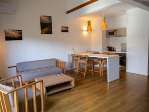 a living room with a couch and a table at Le Pacifik Kone in Koné