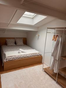 a bedroom with a large bed with a skylight at LOFT cosy in Poitiers