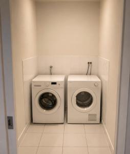 a laundry room with a washer and a dryer at ClickClock Hotel in Melbourne