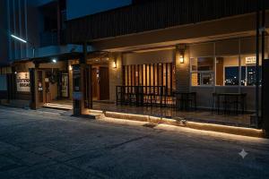 an empty street in front of a building at night at JT Place Buriram in Buriram