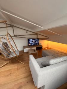 a living room with a couch and a swing at LOFT cosy in Poitiers