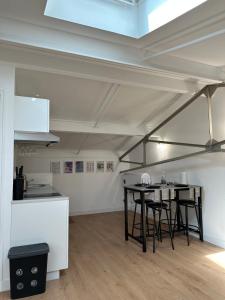 a kitchen with a table and chairs in a room at LOFT cosy in Poitiers