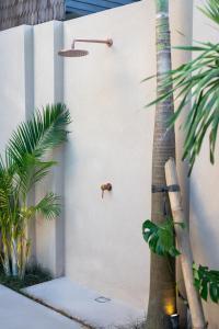 a white door with a palm tree next to it at The Sirocco Villas Bingin by Sandara in Bingin Beach