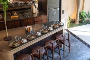 a table with plates and glasses on it in a kitchen at The Sirocco Villas Bingin by Sandara in Bingin Beach