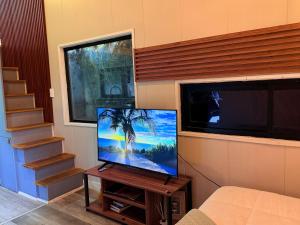 a flat screen tv sitting on a table in a room at Casa Panal , Jacuzzi opcional Villa Alemana in Villa Alemana +13 photos