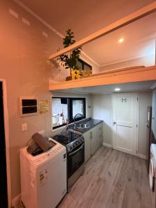 a kitchen with a sink and a stove top oven at Casa Panal , Jacuzzi opcional Villa Alemana in Villa Alemana