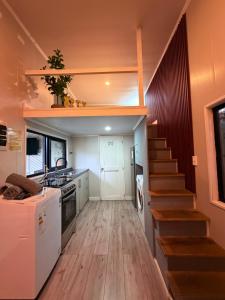 a kitchen with a staircase and a kitchen with a stair case at Casa Panal , Jacuzzi opcional Villa Alemana in Villa Alemana