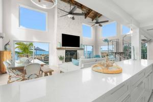 a kitchen and living room with a couch and a tv at Blanco Bay Key in Duck Key