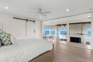a bedroom with a bed and a view of the ocean at Blanco Bay Key in Duck Key