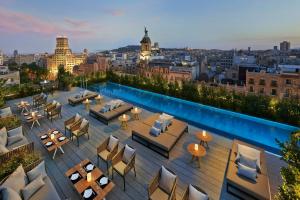 a rooftop bar with a view of a city at Mandarin Oriental, Barcelona in Barcelona