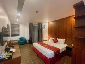 a hotel room with a bed and a desk at Rosy Hotel in Hanoi +14 photos