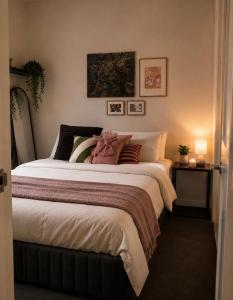 a bedroom with a large bed with pillows at ClickClock Hotel in Melbourne