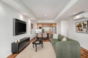 a living room with a couch and a tv at Urban Rest Melbourne in Melbourne +111 photos