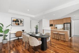 a kitchen and dining room with a table and chairs at Urban Rest Melbourne in Melbourne