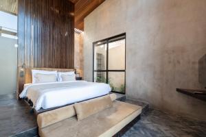 a bedroom with a large bed and a window at The Sirocco Villas Bingin by Sandara in Bingin Beach +100 photos